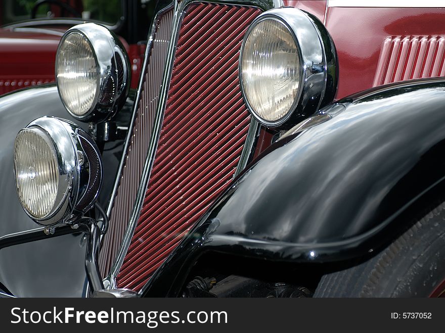 Grid of the old car radiator with three lamps