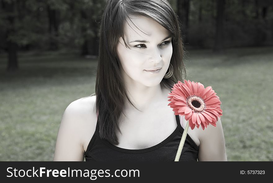 Young Beautiful Woman With Red Flower Outdoors