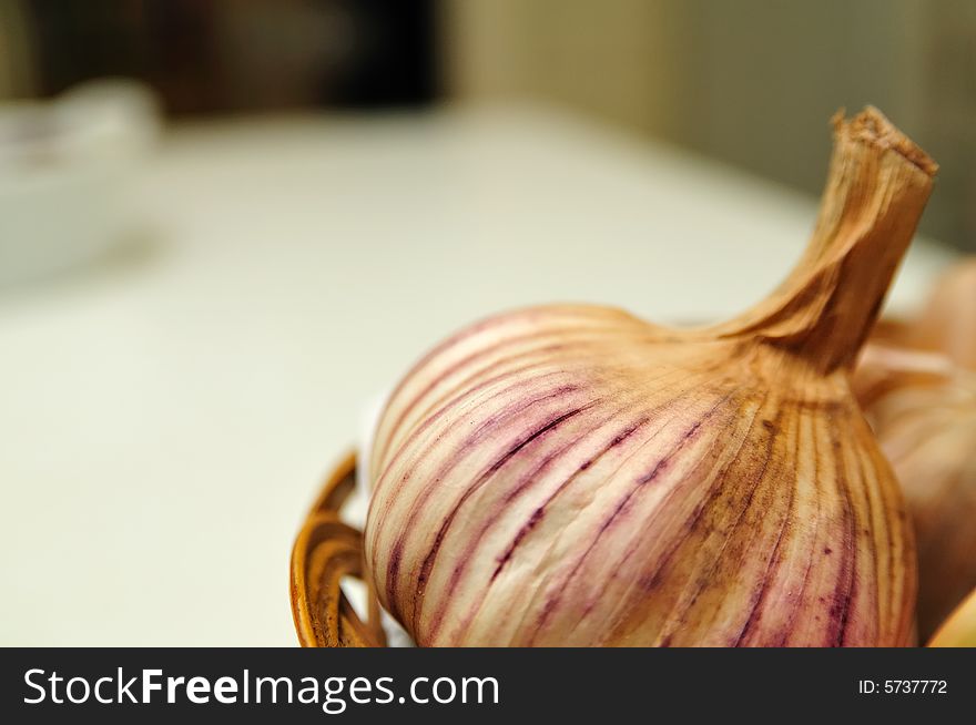 Close shot of a big garlic bulb in a kitchen