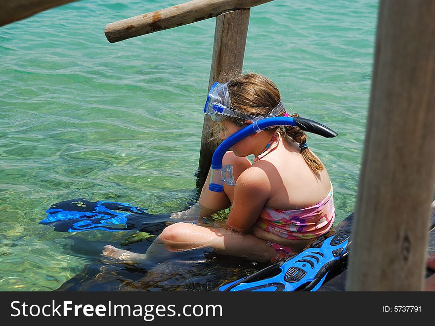 Girl Putting On Snorkeling Gear