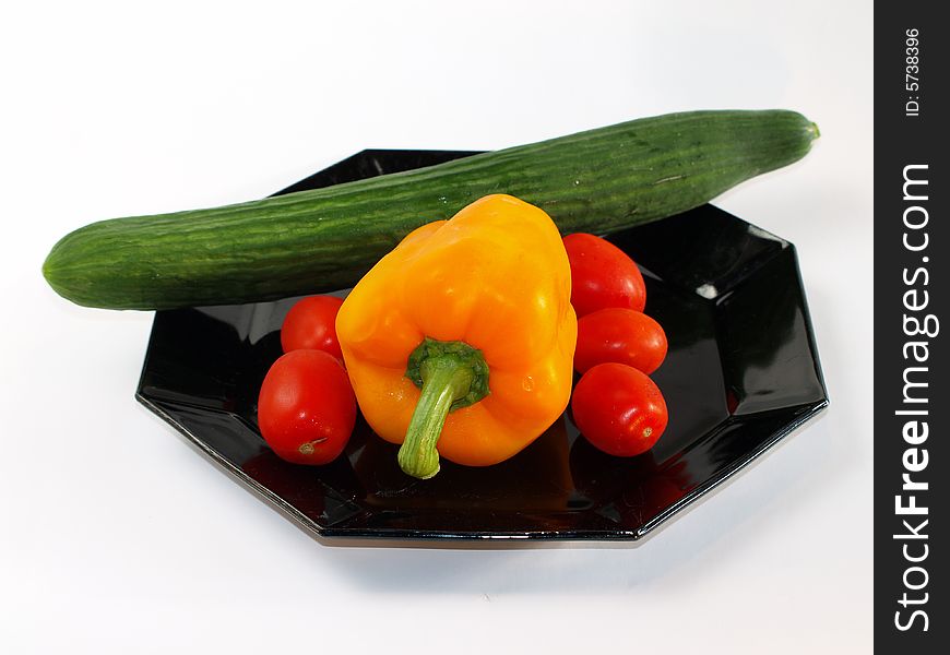 Fresh colorful vegetable on black dish