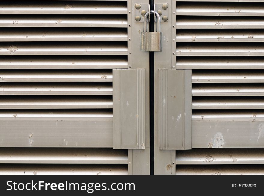 Locks on a gate meant to keep outsiders out. Locks on a gate meant to keep outsiders out