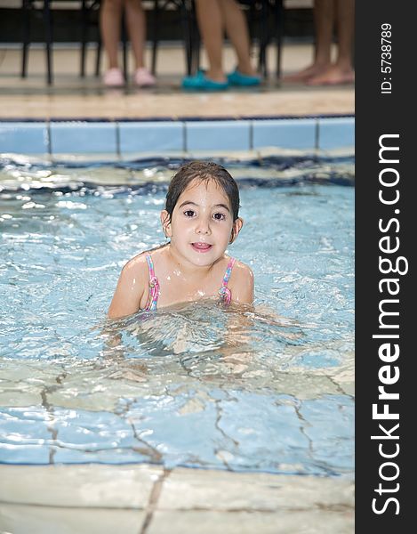 Girl lying down in a swimming pool. Girl lying down in a swimming pool