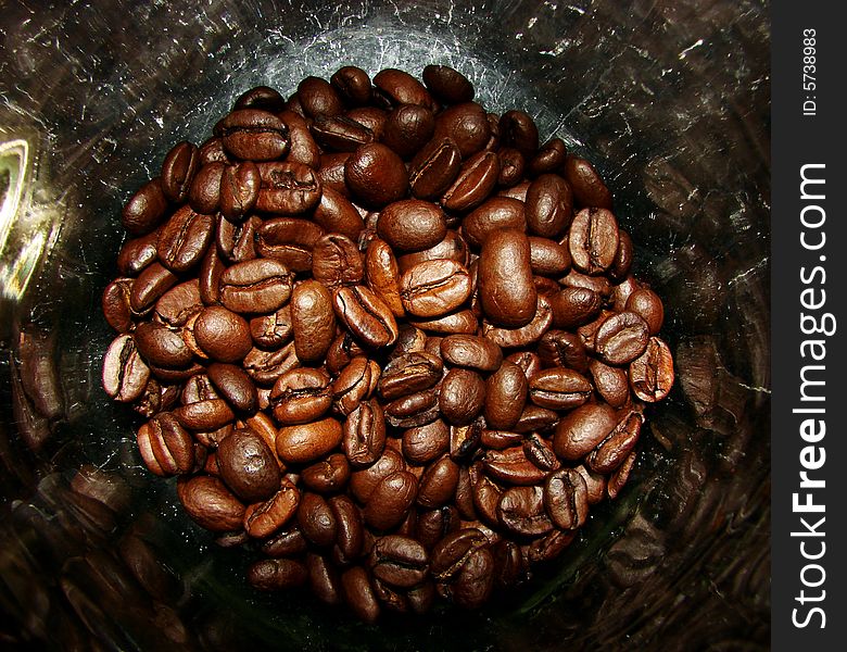 Close up of coffee beans in a jar.
nice reflection from the glass.