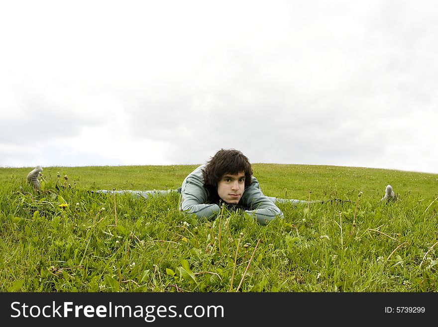 Yogi man sitting at the twine on the grass. Yogi man sitting at the twine on the grass