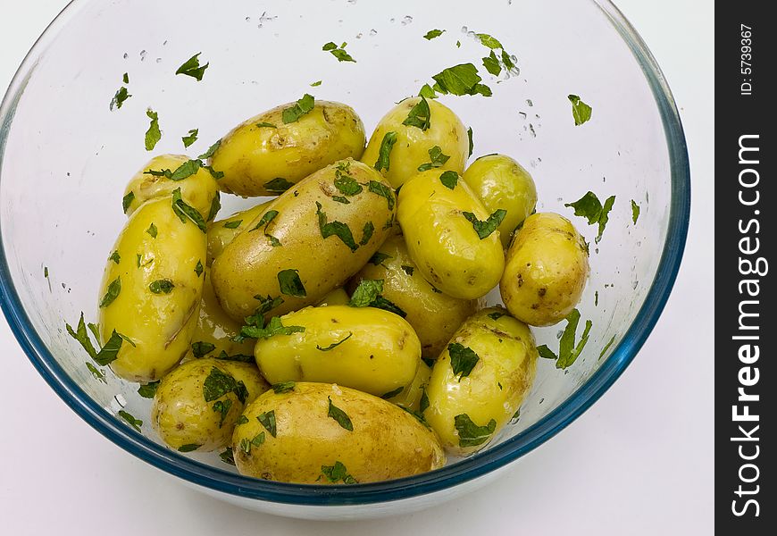 Boiled potatoes with oil and mint ready for transferring into a serving dish. Boiled potatoes with oil and mint ready for transferring into a serving dish.