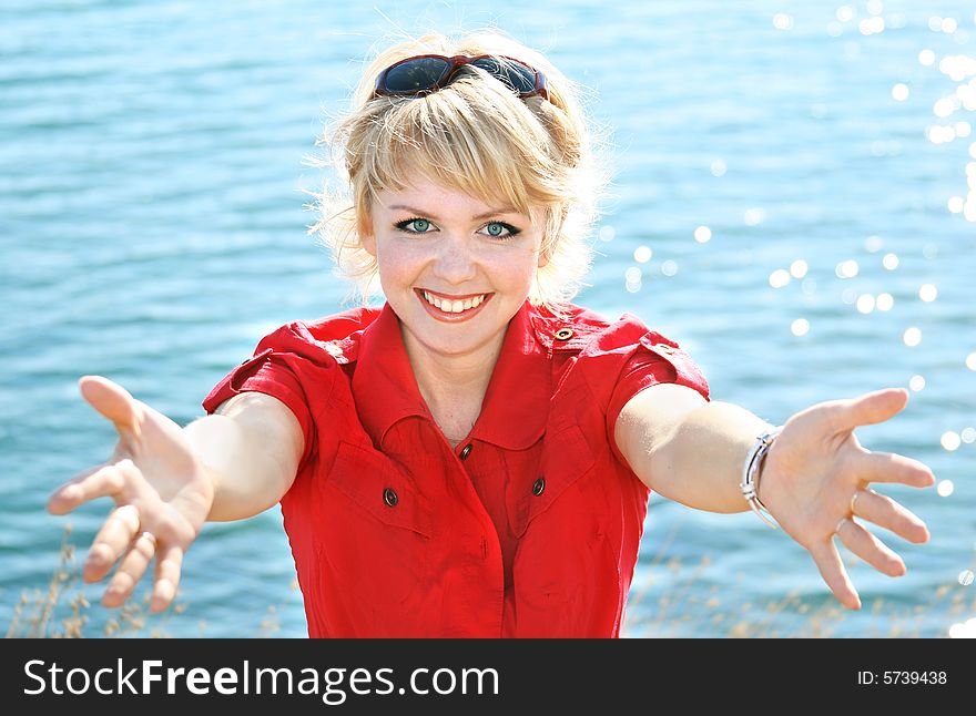 Beautiful blonde in a red dress on a sea resort. Beautiful blonde in a red dress on a sea resort