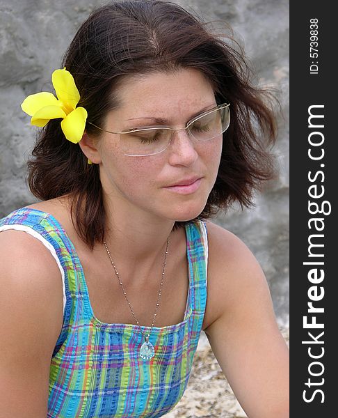 The portrait of a dreaming girl with a tropical flower in her hair (Nassau, The Bahamas). The portrait of a dreaming girl with a tropical flower in her hair (Nassau, The Bahamas).