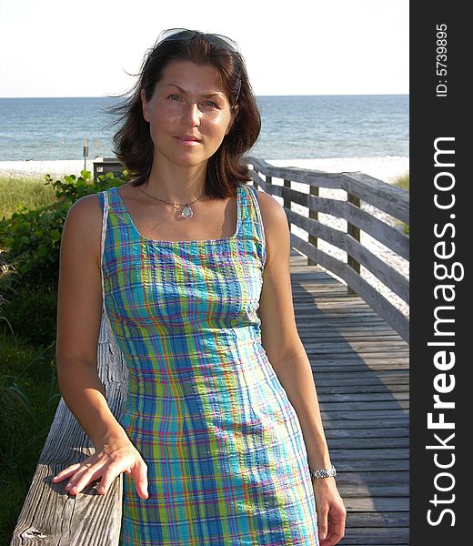 The girl in blue dress on her way to Sanibel Island beach in Florida.