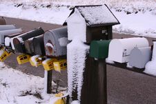 A Row Of Snowy Mailboxes Stock Image