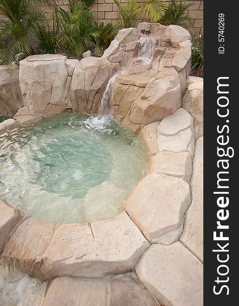 Tropical Custom Pool Jacuzzi with rocks and waterfalls.