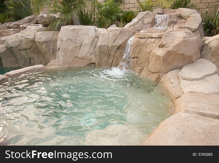 Tropical Custom Pool Jacuzzi with rocks and waterfalls.