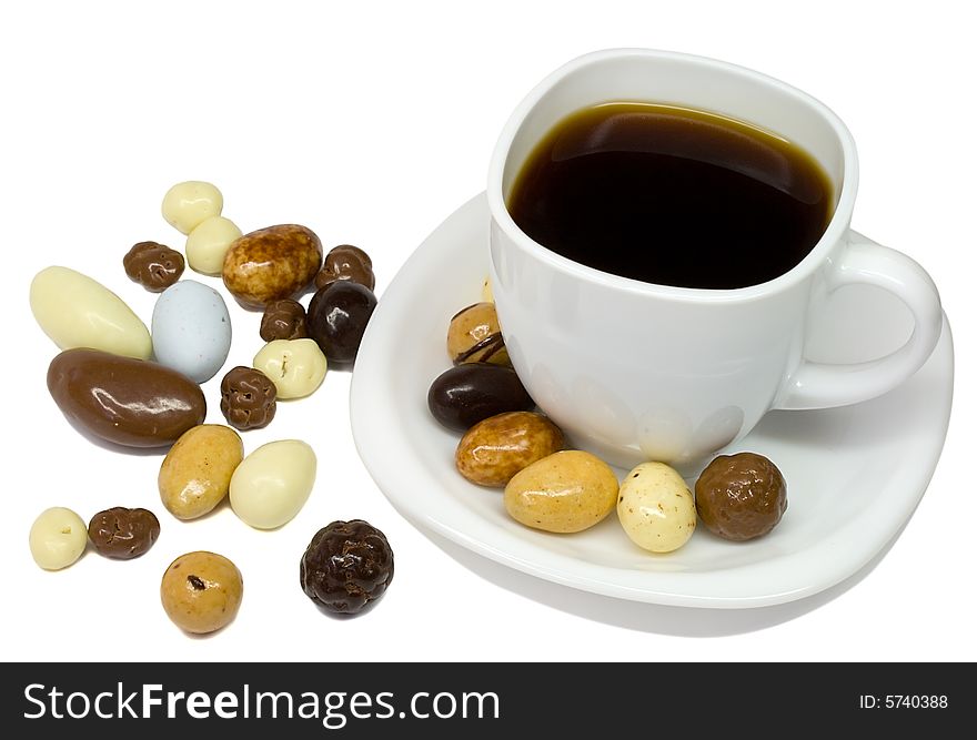 Close-up coffee cup with candies, isolated on white. Close-up coffee cup with candies, isolated on white