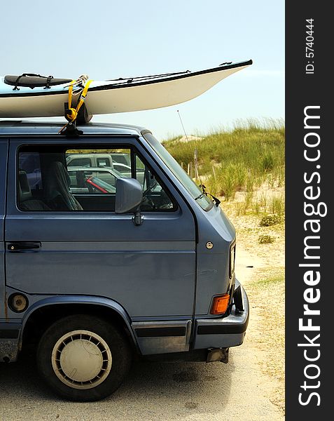 Old volkswagen bus with surfboards on the beach