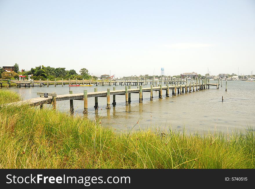 A long pier over the lake with blue skies. A long pier over the lake with blue skies