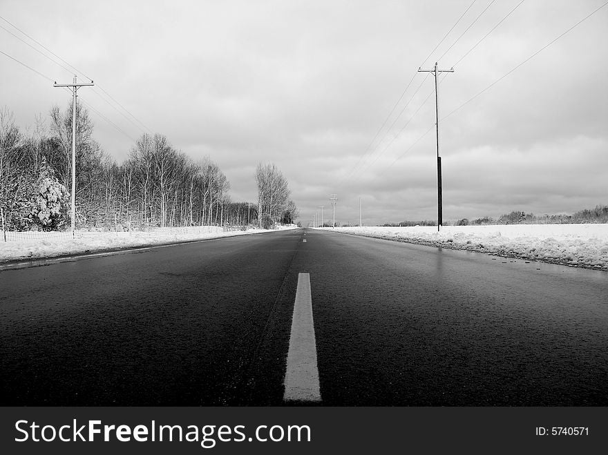 Highway 10 in Michigan.  The cold winter black ice covered road. Dangerous, yet beautiful in this chilling frozen environment. Highway 10 in Michigan.  The cold winter black ice covered road. Dangerous, yet beautiful in this chilling frozen environment.