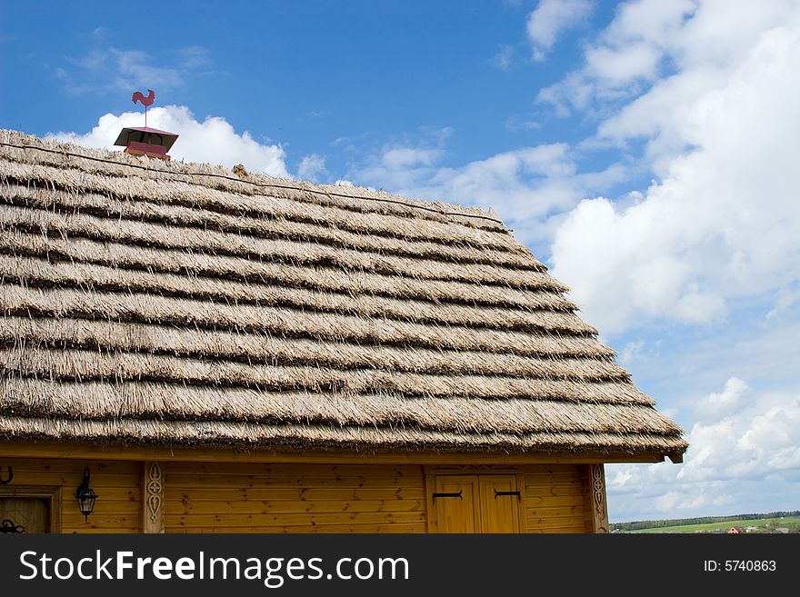 The roof of rural house with wheathercock