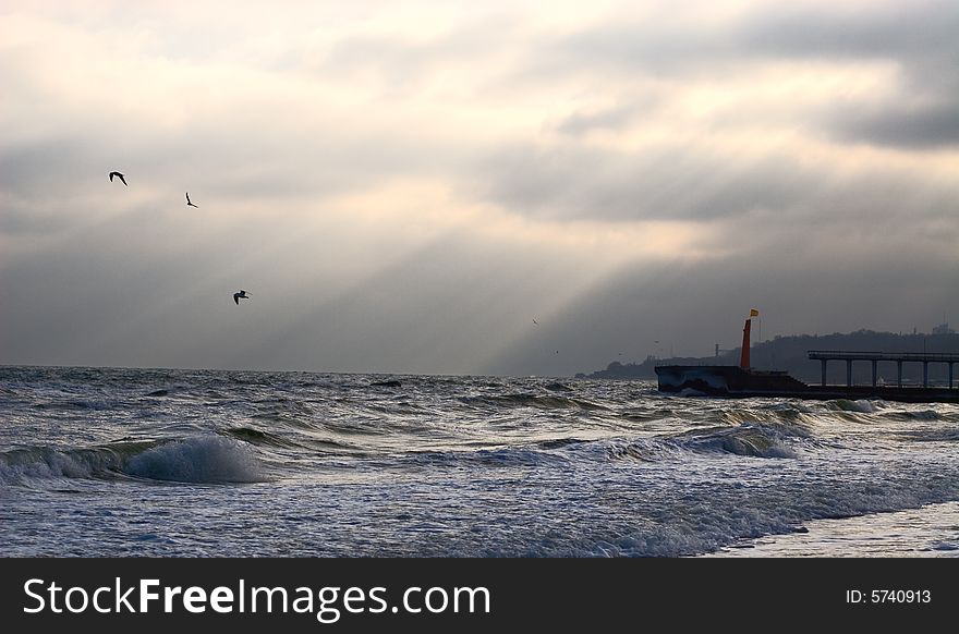 Evening sea landscape with gulls and lighthouse