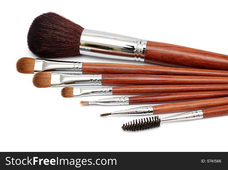 Many different size makeup brush on white background.