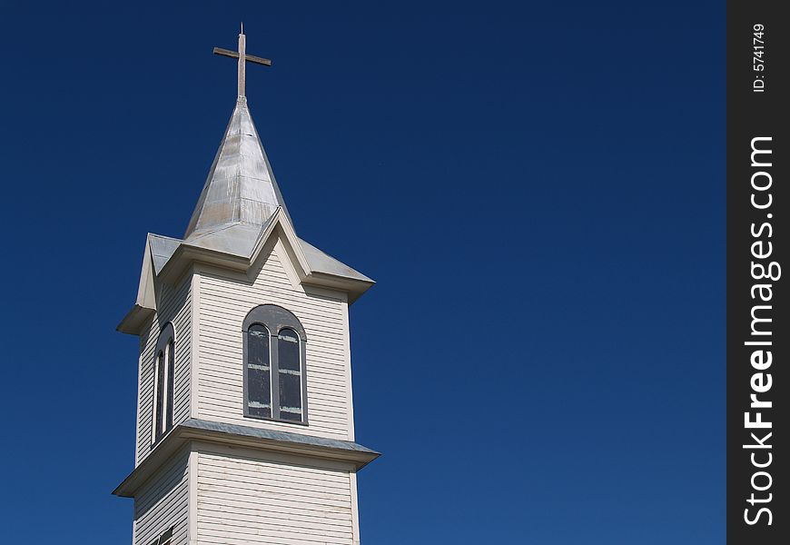 Old White Church Steeple against Blue Sky