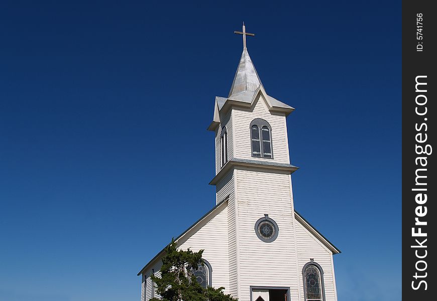 Rural White Church against bright blue sky