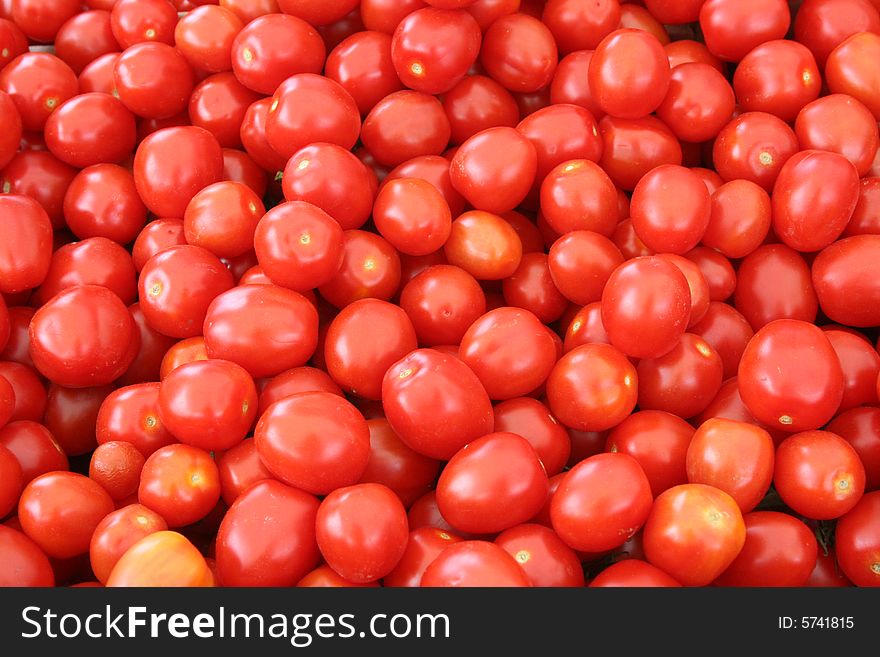 Bright red tomatoes at a produce stand.