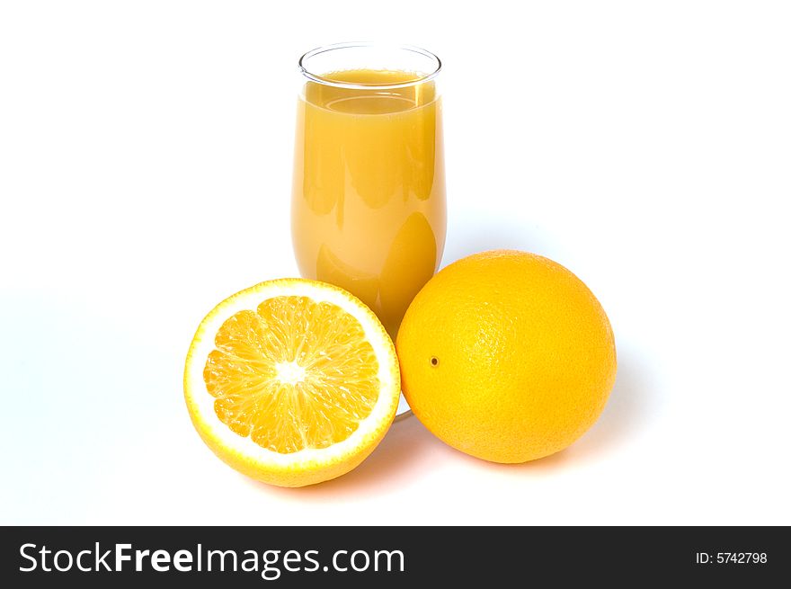 Two oranges and orange juice in the glass isolated on white. Two oranges and orange juice in the glass isolated on white