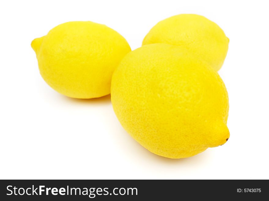 Three lemons put together on white background.