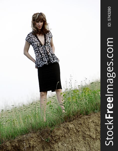 A beautiful girl walking near the lake