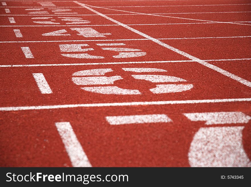 Finish line and track numbers of red running tracks. Finish line and track numbers of red running tracks