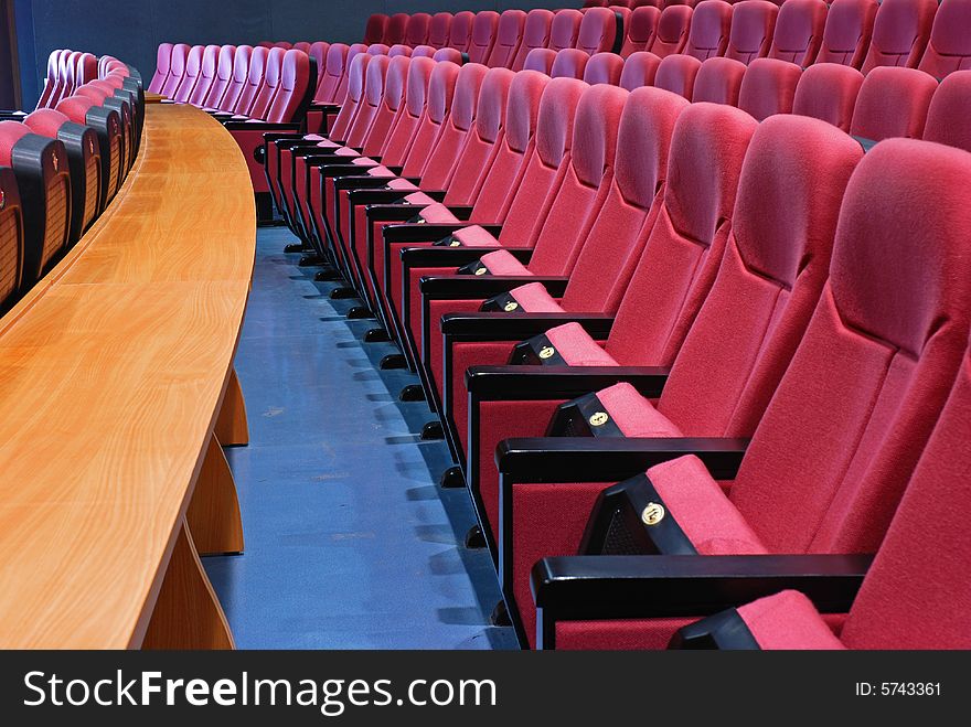 Empty cinema seats with long table in front