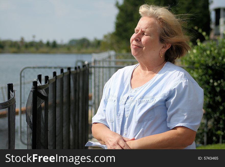 Photo of a happy senior by the waterfront