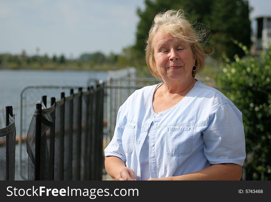 Photo of a happy senior by the waterfront