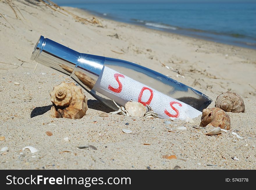 Message in a bottle with red SOS signal