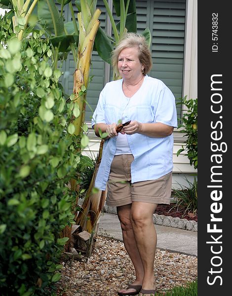 Photo of a senior doing some yard work. Photo of a senior doing some yard work