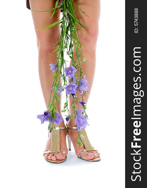 Long legs on high heels with flowers on white