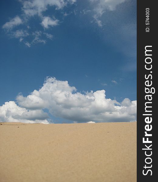 View of a Sand on background desert with clouds