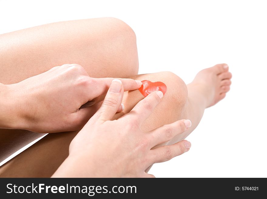 Applying red plaster on knee