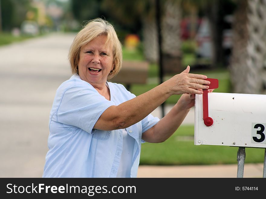 Photo of a senior checking the mail box. Photo of a senior checking the mail box