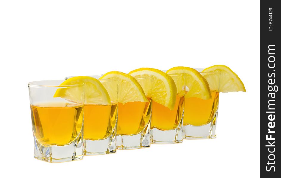 Drink and slices of a fresh lemon isolated on white background. Drink and slices of a fresh lemon isolated on white background.