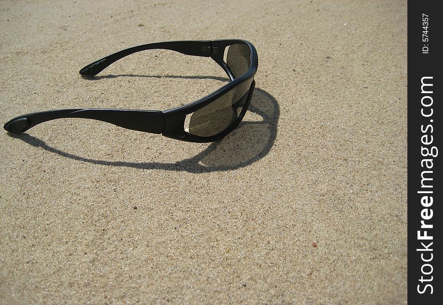 View of Solar glasses on sand