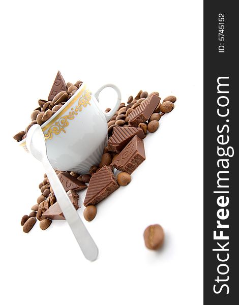 Coffee beans and chocolate in the cup on a white background. Coffee beans and chocolate in the cup on a white background