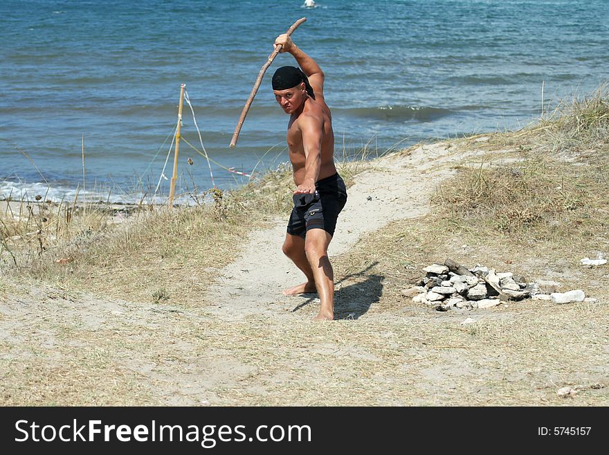 Man in karate stance on the beach