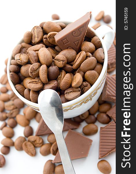 Coffee beans and chocolate in the cup on a white background. Coffee beans and chocolate in the cup on a white background