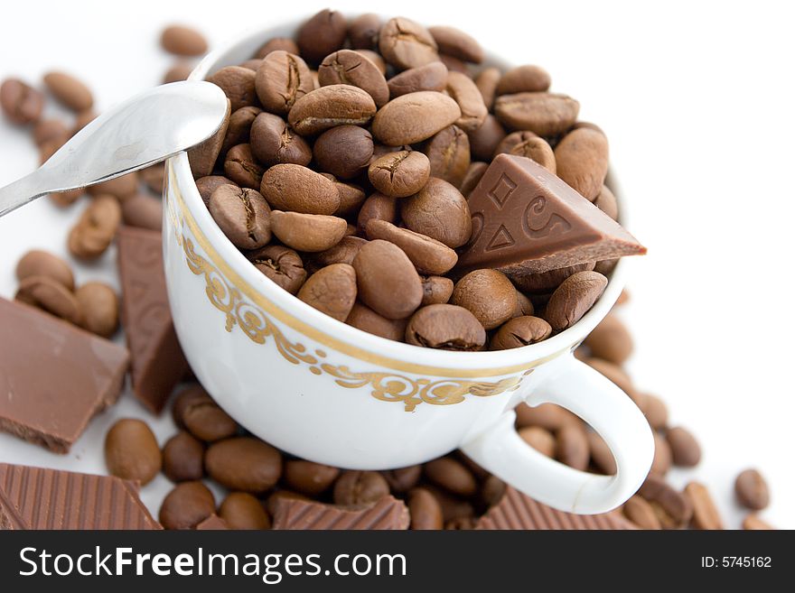 Coffee beans and chocolate in the cup on a white background. Coffee beans and chocolate in the cup on a white background