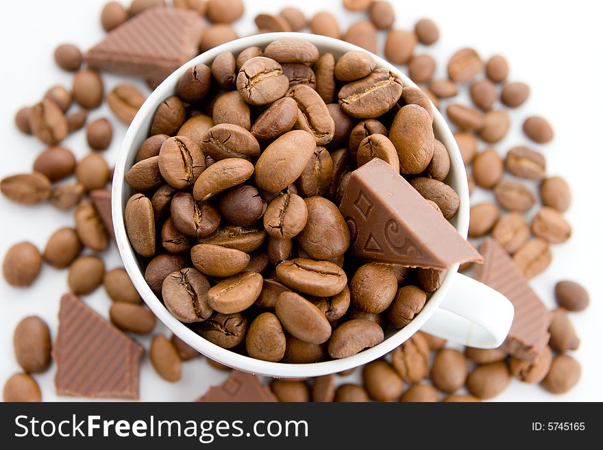 Coffee beans and chocolate in the cup on a white background. Coffee beans and chocolate in the cup on a white background