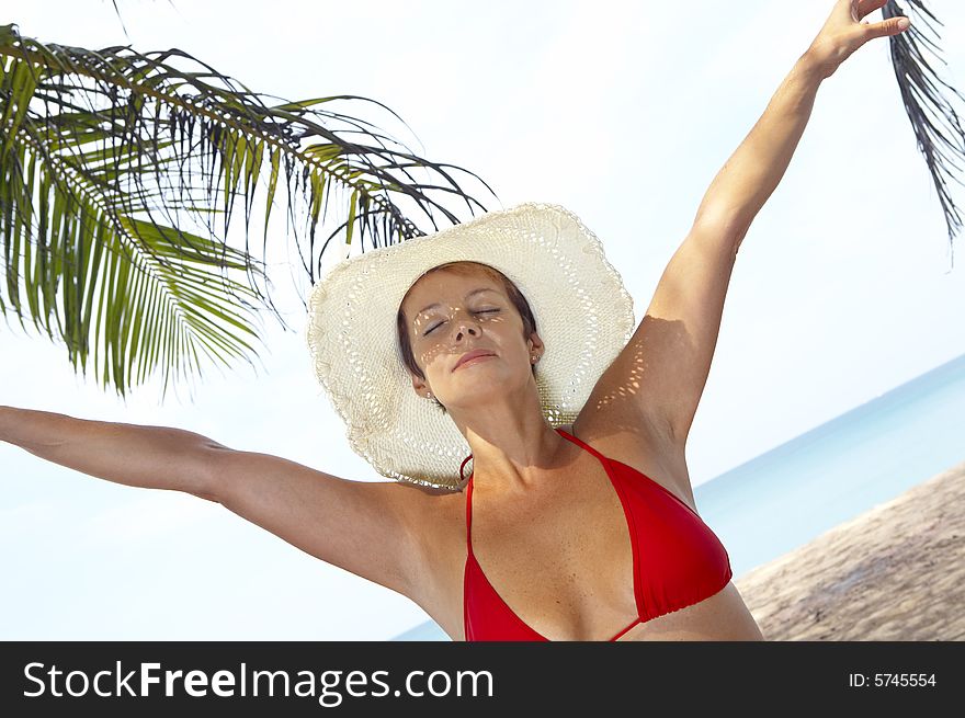 View of nice woman having fun on tropical beach. View of nice woman having fun on tropical beach