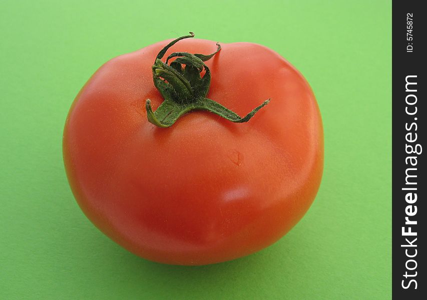 Tomato on a green background