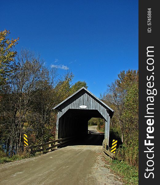 Covered bridge in autumn in the province of Quebec in Canada. Covered bridge in autumn in the province of Quebec in Canada