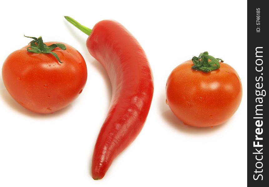 Two fresh tomatoes and a ripe chili pepper isolated on white background. Two fresh tomatoes and a ripe chili pepper isolated on white background